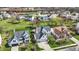 Aerial view showcasing residential homes with well-kept lawns and a community pond at 6571 Hunters S Rdg, Zionsville, IN 46077