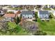 An aerial shot of backyard featuring a stone patio with an outdoor kitchen and trampoline, set in a green lawn at 6571 Hunters S Rdg, Zionsville, IN 46077