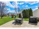 Backyard patio with dining set, play structure, grill, and lush green lawn under a bright sky at 6571 Hunters S Rdg, Zionsville, IN 46077