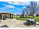 Spacious backyard with gazebo, patio dining set, trampoline, and well-manicured lawn at 6571 Hunters S Rdg, Zionsville, IN 46077