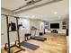 Basement exercise room with hardwood flooring, a treadmill, and space for other gym equipment at 6571 Hunters S Rdg, Zionsville, IN 46077