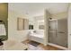 Bright bathroom featuring a shower, a tub beneath a window, and neutral decor at 6571 Hunters S Rdg, Zionsville, IN 46077