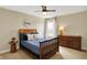 Bedroom with wood furniture, a ceiling fan, and a window with natural light at 6571 Hunters S Rdg, Zionsville, IN 46077
