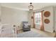 Bedroom with a grey recliner, basket decorations, and a white crib at 6571 Hunters S Rdg, Zionsville, IN 46077