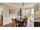 Inviting dining room boasts hardwood floors, natural light from the large bay window, and elegant furnishings at 6571 Hunters S Rdg, Zionsville, IN 46077