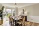 Bright dining room features a chandelier, modern table setting, and bay windows with an outside view at 6571 Hunters S Rdg, Zionsville, IN 46077