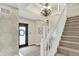 Elegant foyer featuring a staircase, chandelier, and decorative wallpaper, creating a welcoming entrance at 6571 Hunters S Rdg, Zionsville, IN 46077