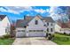 Beautiful two-story home with a three-car garage, manicured lawn, and classic architectural details at 6571 Hunters S Rdg, Zionsville, IN 46077