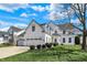 Charming two-story home featuring a three-car garage, manicured lawn, and classic white siding at 6571 Hunters S Rdg, Zionsville, IN 46077