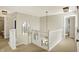 Bright hallway featuring white railings, stylish light fixtures, and access to various rooms in the home at 6571 Hunters S Rdg, Zionsville, IN 46077