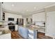 This modern kitchen offers stainless appliances, white cabinets, granite countertops, and a blue center island at 6571 Hunters S Rdg, Zionsville, IN 46077