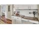 Charming kitchen with granite counters, white cabinetry, and stainless steel appliances with an open floorplan at 6571 Hunters S Rdg, Zionsville, IN 46077