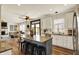 Open kitchen and dining area featuring a kitchen island with seating and stainless steel appliances at 6571 Hunters S Rdg, Zionsville, IN 46077