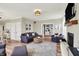 Bright living room featuring a fireplace, hardwood floors, and comfortable seating arrangement at 6571 Hunters S Rdg, Zionsville, IN 46077