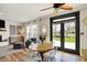 The bright living room features a fireplace, wood floors, neutral decor and a view to the backyard at 6571 Hunters S Rdg, Zionsville, IN 46077