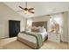 Inviting main bedroom with a vaulted ceiling, a ceiling fan, and windows, creating a cozy and serene retreat at 6571 Hunters S Rdg, Zionsville, IN 46077