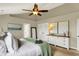 Spacious bedroom with a ceiling fan, green blanket, dresser, and decor, offering style and storage at 6571 Hunters S Rdg, Zionsville, IN 46077