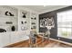 The office features hardwood floors, built-in shelving, and modern glass desk at 6571 Hunters S Rdg, Zionsville, IN 46077