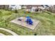 Aerial view of a playground offering swings, slides, and climbing equipment in a safe, landscaped environment at 6571 Hunters S Rdg, Zionsville, IN 46077