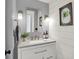 Charming powder room featuring shiplap walls, modern vanity, and decorative mirror, creating a stylish and inviting space at 6571 Hunters S Rdg, Zionsville, IN 46077