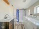 Bathroom with shower, toilet, washing machine, and dryer at 6616 W Thompson Rd, Indianapolis, IN 46241