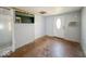 Bedroom with a TV mounted on the wall, two doors, and air conditioning, providing convenience and comfort at 6616 W Thompson Rd, Indianapolis, IN 46241