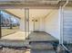 Covered front porch featuring classic railings and a concrete entryway, offering a welcoming exterior detail at 6616 W Thompson Rd, Indianapolis, IN 46241