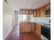An outdated kitchen with light wood cabinets and a view to the backyard at 6616 W Thompson Rd, Indianapolis, IN 46241