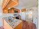 Spacious kitchen features wood cabinets, granite countertops, and a view to a living space at 6616 W Thompson Rd, Indianapolis, IN 46241