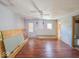 Large living room with ceiling fan and hardwood floors needs finishing at 6616 W Thompson Rd, Indianapolis, IN 46241