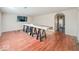 Open-concept living room with wood floors, a modern entertainment setup, and an airy feel at 6616 W Thompson Rd, Indianapolis, IN 46241