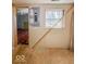 Bright room with paneled walls and hardwood floors is ready for remodel at 6616 W Thompson Rd, Indianapolis, IN 46241