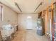 Bright utility room with water heater, sink, and convenient exterior access to the backyard at 6616 W Thompson Rd, Indianapolis, IN 46241