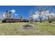 This brick home boasts a lush backyard with a brick fire pit and an outdoor dining set on the patio at 7152 Sandalwood Dr, Avon, IN 46123