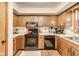 Traditional kitchen features wood cabinets, black appliances, and laminate countertops at 7152 Sandalwood Dr, Avon, IN 46123
