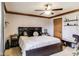 Spacious main bedroom boasts neutral walls, ceiling fan, plush bed, and unique shelving at 7152 Sandalwood Dr, Avon, IN 46123