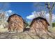 Two wooden outbuildings with double doors add character to the property's backyard at 7152 Sandalwood Dr, Avon, IN 46123