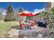 This outdoor patio features a table and 4 chairs with an orange umbrella, and a black grill at 7152 Sandalwood Dr, Avon, IN 46123