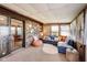 Relaxing sunroom features brick accent wall, comfortable seating, and sliding glass door at 7152 Sandalwood Dr, Avon, IN 46123