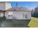 A cozy home backyard featuring a sliding door, ample lawn, and a well-maintained exterior at 7236 Wyatt Ln, Indianapolis, IN 46217