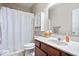 Cozy bathroom featuring a shower with white curtain, toilet and vanity at 7236 Wyatt Ln, Indianapolis, IN 46217