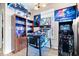 Finished game room with pinball machine, arcade game and bookcase filled with movies at 7236 Wyatt Ln, Indianapolis, IN 46217