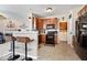 Stylish kitchen with wood cabinets, modern appliances, and convenient breakfast bar at 7236 Wyatt Ln, Indianapolis, IN 46217