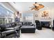Spacious living room with a ceiling fan, large windows, and fireplace at 7236 Wyatt Ln, Indianapolis, IN 46217