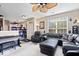 Comfortable living room featuring a ceiling fan, piano, and ample seating at 7236 Wyatt Ln, Indianapolis, IN 46217