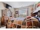 Comfortable bedroom with a large window letting in natural light, dresser and a TV at 7236 Wyatt Ln, Indianapolis, IN 46217
