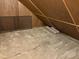 Unfinished attic with wood-paneled walls and ceiling and carpeted floors at 7902 Benjamin Dr, Lawrence, IN 46226