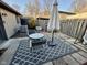 Backyard patio featuring a table and chairs with an umbrella, and an air conditioning unit at 7902 Benjamin Dr, Lawrence, IN 46226