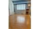 A spacious room with light hardwood floors, a built-in shelf, and a bright window at 7902 Benjamin Dr, Lawrence, IN 46226