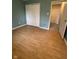 A cozy bedroom featuring sleek, hardwood floors and a large, functional closet for ample storage at 7902 Benjamin Dr, Lawrence, IN 46226